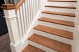 Wooden staircase with white railings and baseboard