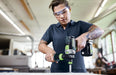 Person using a Festool cordless drill in an indoor setting