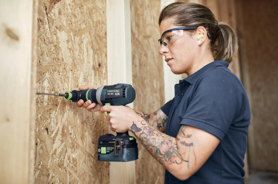 Person using a Festool 577627 drill on a wooden surface