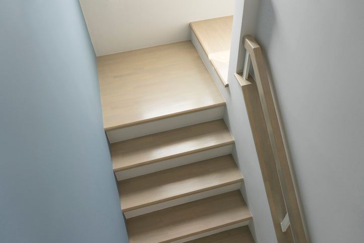 Beige staircase with a handrail in a minimalistic setting
