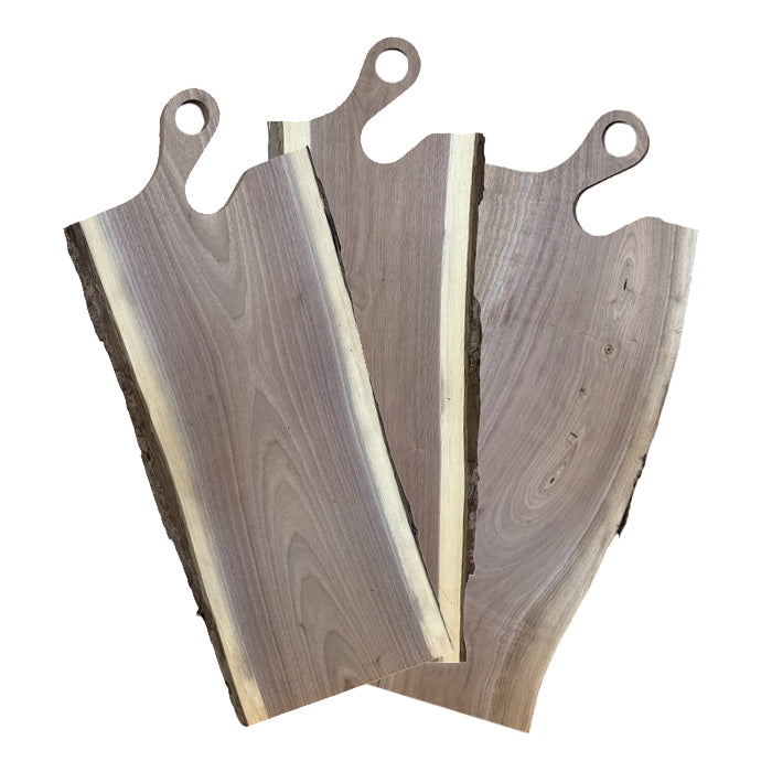 Three wooden cutting boards with handles on a white background