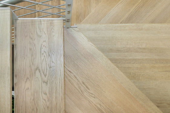 Close-up of a wooden gate with a metal lattice design.